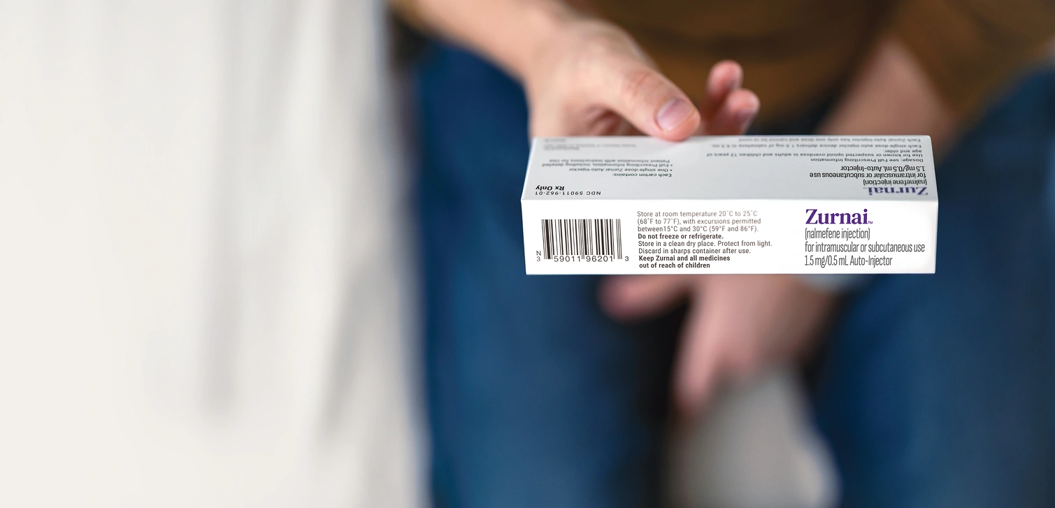 Hand holding the ZURNAI carton