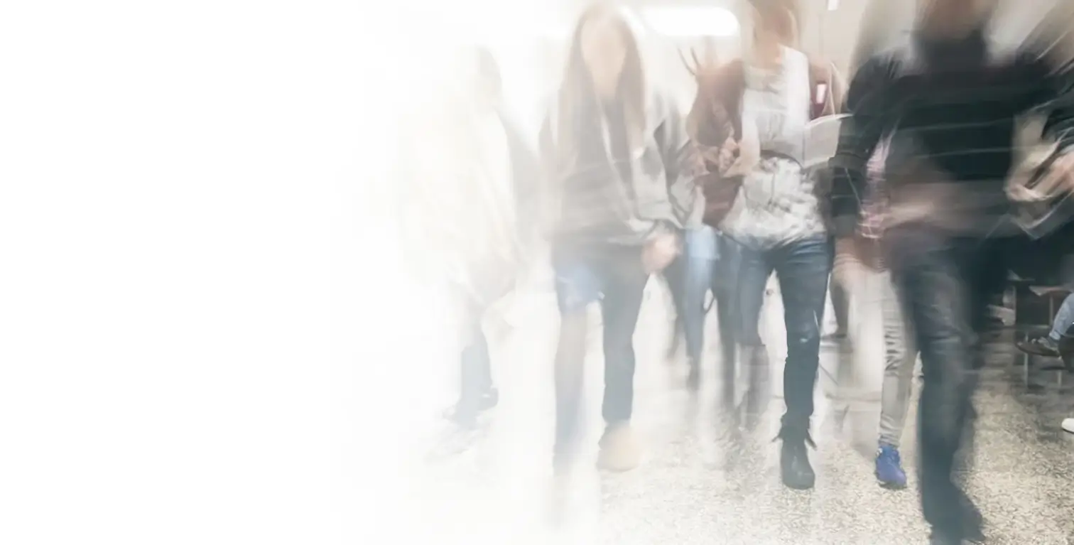 Actor portrayals of students walking a hallway